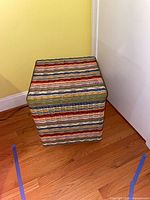 Closed wicker trunk showing multicolor stripe exterior