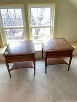 Both end tables front view under window