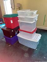 Stack of clear, red/green, black and purple totes