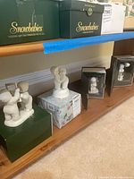 Shelf view showing four Snowbabies figurines with boxes