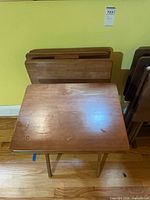 Unfolded tray table with folded tables behind