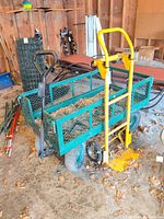 Green wagon and yellow hand truck together