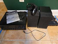 Group shot showing receiver, speakers, headphone stand and manual