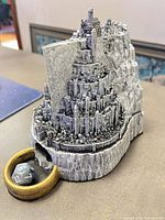 Front view of resin fortress dice tower showing wooden ring tray and d20