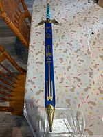 Sword inside scabbard on table showing full length and detailing