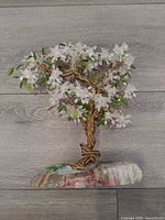 Full view of twisted wire tree on stone base