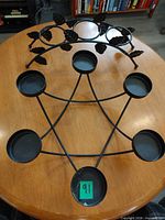 Both candle holders displayed: Star of David holder with six plates; arch holder with leaf accents
