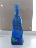 Front view showing full bottle shape and color