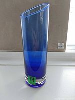 Full view of blue glass vase standing upright