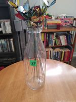 glass bottle with butterfly stems inside, full view
