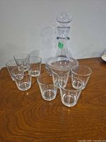 decanter and eight tumblers grouped on table