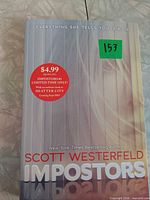 Front cover with title, author, promotional sticker