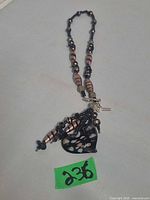 Full view of necklace showing bead pattern and heart pendant