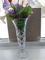 Full view of crystal vase with artificial flowers