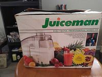 Juiceman Professional Series 210 juicer retail box showing branding and model