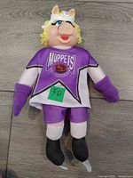 Front view of Miss Piggy plush showing full outfit and logo