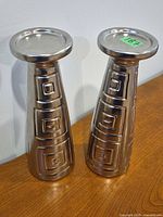 front view of both silvertone metal pedestals