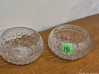 Pair of clear etched glass candy dishes side by side