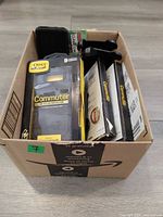 Box with assorted OtterBox cases visible