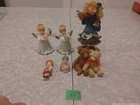 Seven assorted figurines grouped on table