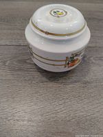 Side view of porcelain jar showing motif and lid