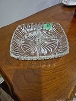 Top view showing square dish, four compartments, starburst pattern, scalloped rim