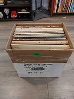 Box of vinyl records showing spines and quantity