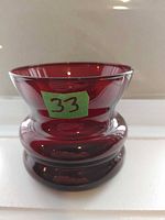 Front view showing full shape and color of red glass vase