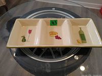 Top view of three-section ceramic dish with graphics