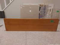 Front view of wooden wall shelf with natural finish