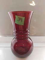 Full view of red vase showing shape and color