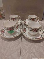 Four teacups each on its matching saucer arranged on table