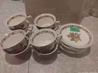 Stacked view showing multiple cups and saucers with pattern visible