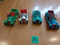 Four vintage-style toy cars lined up