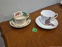 Both cup and saucer sets side by side