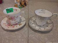Both teacup and saucer sets side by side