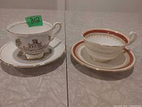 Two teacup and saucer sets side by side showing full designs