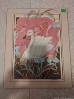 Front view showing complete matted swan print with floral background and artist signature