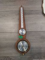 Front view showing thermometer, hygrometer, barometer and overall wooden body