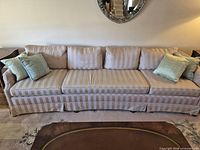 Front view of full sofa with striped upholstery and throw pillows