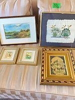 Group view of all five framed prints on sofa