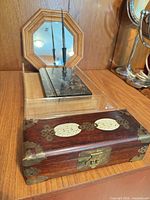 Group view of jewelry box, marble pen stand with pen, and octagonal mirror