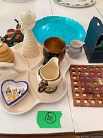 group view showing ceramic trinkets on tray with honey pot, mug, creamer, heart dish, vase, swan rest, glass items