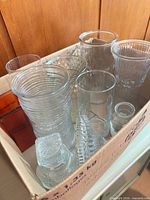 Box containing assorted clear glass vases, jars, decanter and dish