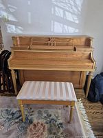 Front view of Heintzman upright piano with bench