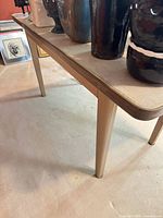 Full view of table showing legs, top surface and surrounding items