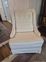 Front view of ivory tufted fabric armchair