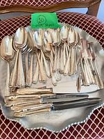 Full set of flatware laid out in tray showing quantity and variety