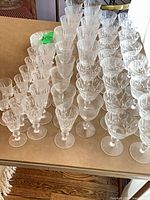 rows of clear cut glass stemware on table