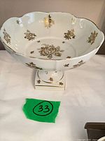 Top view of scalloped white porcelain compote showing gold floral interior decoration